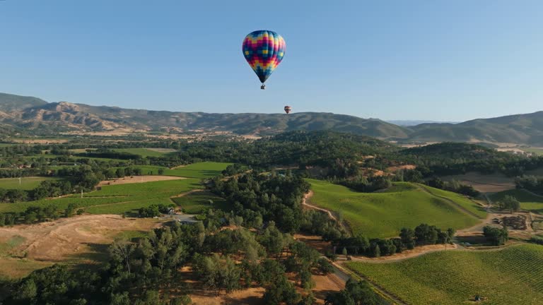 Three Hot Air Balloons Flying in the American countryside during the day