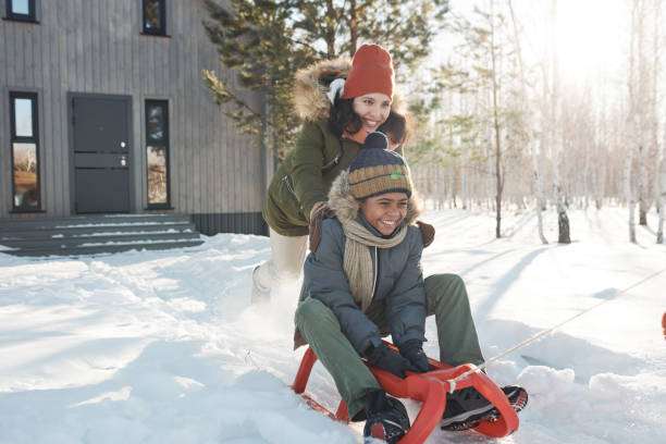 istock Woman pushing sledge with her cute son 1924556001