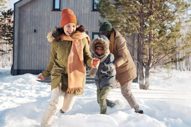 Laughing woman running in snowdrift