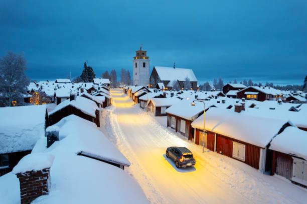 car crossing the village of gammelstad at dusk, aerial view, lulea, sweden - luleå bildbanksfoton och bilder