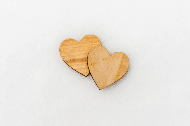 istock Two wooden hearts in the snow, top view,copy space. 1924571156
