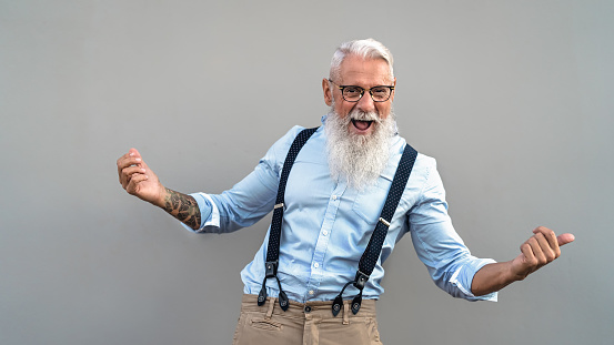 Happy senior man celebrating and laughing in front camera - Fashion elderly male lifestyle concept