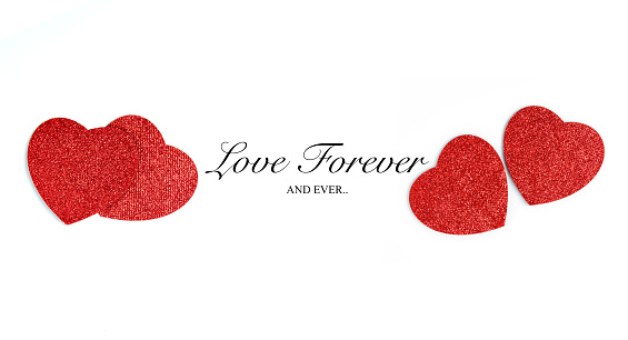 Eternal Love concept. Minimal design with romantic red glitter hearts and written love quote - Love forever and ever. Isolated on white with copy space