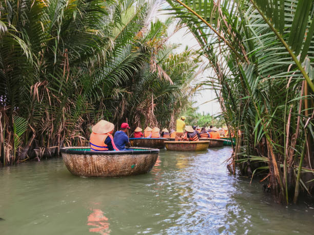 Tourists riding bamboo basket boats in Hoi An, vietnam (Cam Thanh water coconut village ) Tourists riding bamboo basket boats in Hoi An, vietnam (Cam Thanh water coconut village ) basket boat stock pictures, royalty-free photos & images