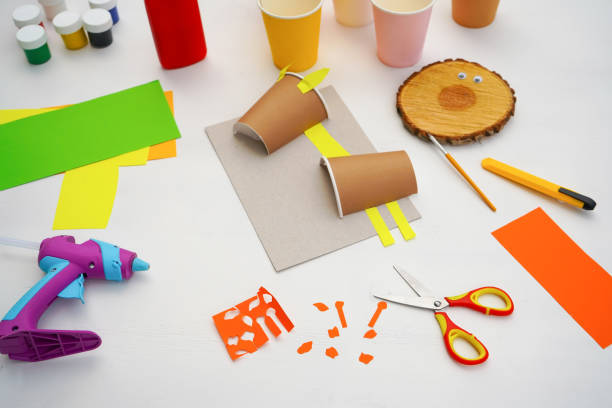 istock Step by step diy process. Point 6 we cut out orange-colored horns and spots from paper. Kids craft giraffe from a paper coffee cup, zero waste concept. 1924601989