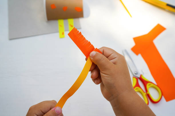 istock Step by step diy process. Point 7 make a ponytail. Kids craft giraffe from a paper coffee cup, zero waste concept. 1924601999