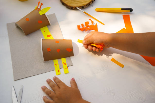 istock Step by step diy process. Point 7 glue a ponytail. Kids craft giraffe from a paper coffee cup, zero waste concept. 1924602000