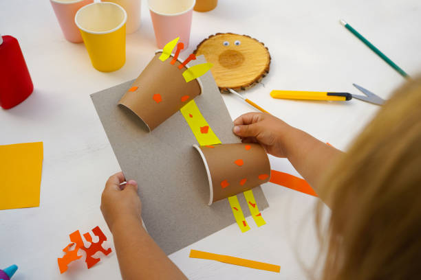istock Step by step diy process. Homemade giraffe applique from a paper cup. Kids craft giraffe from a paper coffee cup, zero waste concept. 1924602003