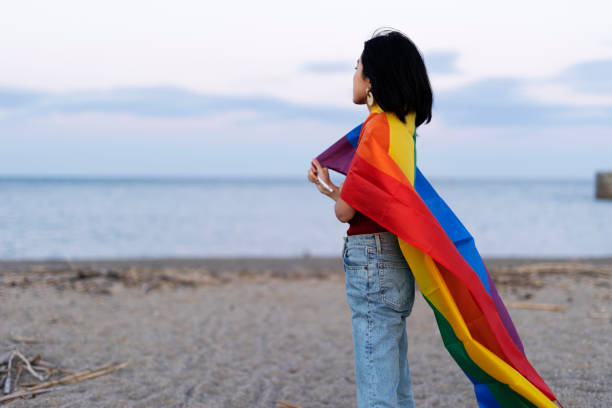 istock Happy girl with a pride flag at the beach. 1924602021