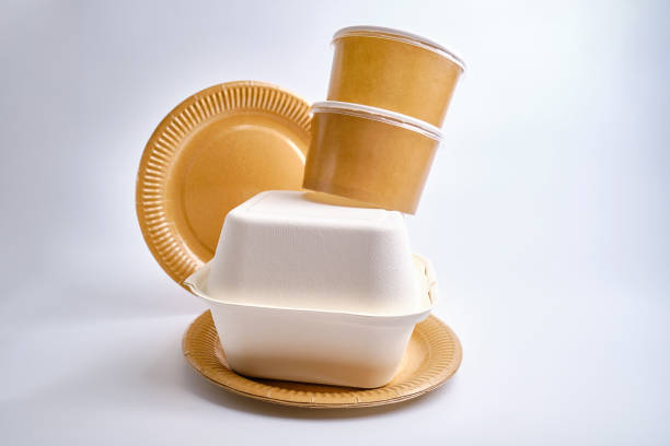 istock Kraft paper tableware: cups, food boxes, isolated on a light background. A set of various disposable tableware. Recycling and zero waste concept. Mock up 1924628026