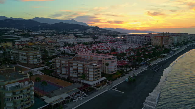 Beachfront Hotels At Sunset By The Sea In Malaga, Spain. aerial shot