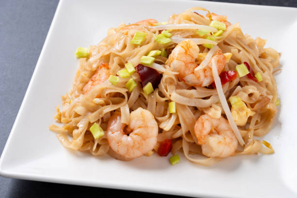istock Pad Thai with shrimp and vegetables on black slate background 1924669779