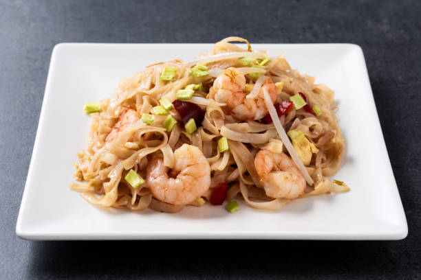 istock Pad Thai with shrimp and vegetables on black slate background 1924669792