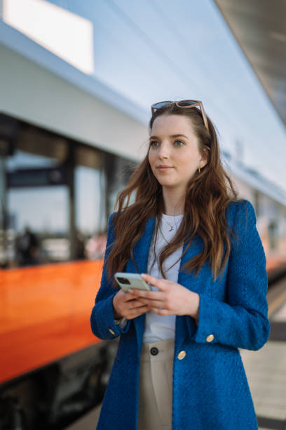 istock Woman entrepreneur commuting to work. Using and holding mobile phone. Public transport concept. 1924678376