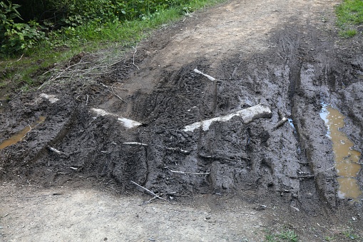 Muddy local road in Wisla, Poland. Rural road problems.
