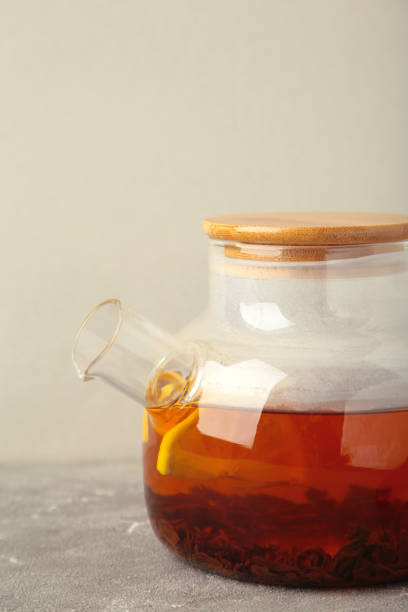 istock Black tea with lemon on grey background. Vertical photo 1924713286