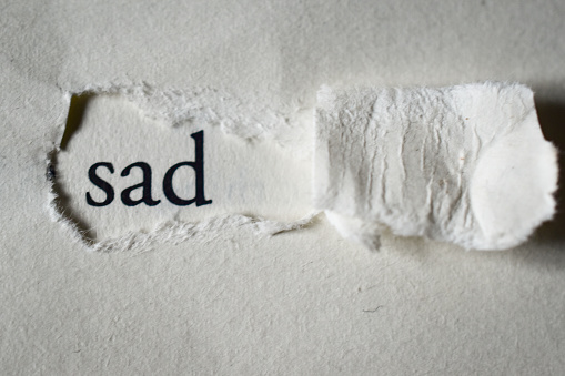 A page of a book with the word sad written on it