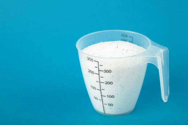istock Measuring spoon with washing powder on blue background 1924719799