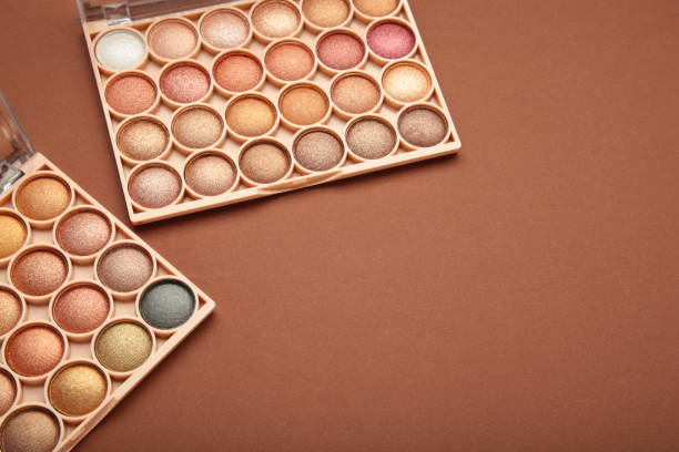 istock Pastel palette of eyeshadow on brown background. Space for text 1924721470