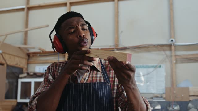 Young African man working in his carpentry workshop