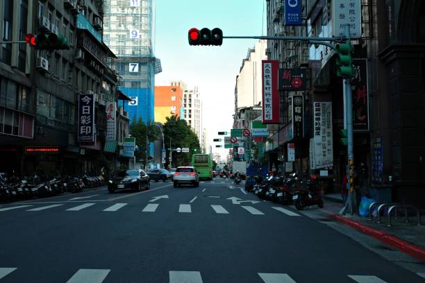 the empty street is full of motorcyclists at an intersection Taipe, Taiwan – November 17, 2023: A bustling street corner is filled with a variety of motorcyclists, all gathered together at the intersection Revving stock pictures, royalty-free photos & images