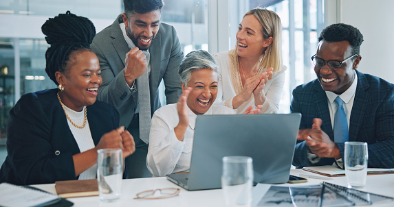 Laptop, business people and group celebrate, applause and cheers for project, revenue or achievement. Online statistics, data analytics and team clapping for success results, feedback report or news