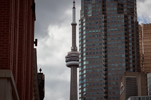 Toronto, Canada; 11th of October, 2023. View of the CN Tower from Church Street in a cloudy evening in Toronto