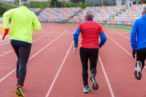 istock Active Senior Friends Running Together On Track 1924761038