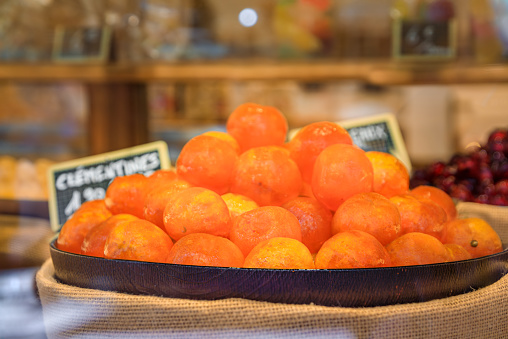 Whole candied clementine citrus fruit on display at a confectionery store in the medieval town of Colmar, France, Alsatian Wine Route village