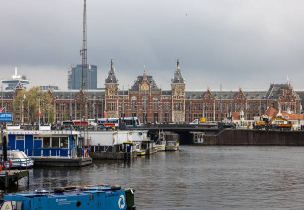 Amsterdam, Netherlands - April 21, 2023:  Central station on Damrak street in Amsterdam.