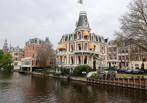 Amsterdam, Netherlands - April 21, 2023: The canal and architecture typical of the center of Amsterdam in the area of the Rijksmuseum