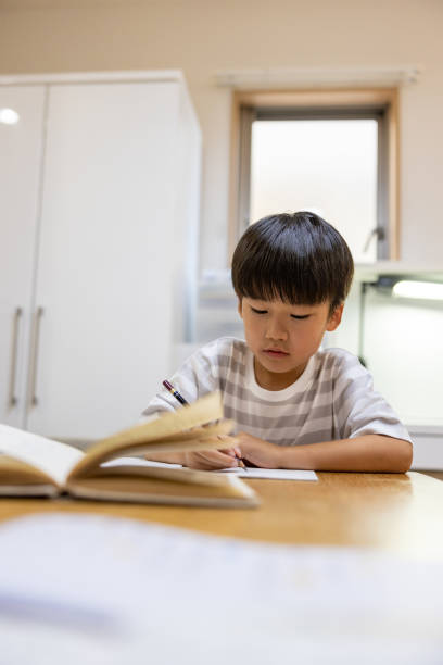 istock Little boy studying at home 1924797156