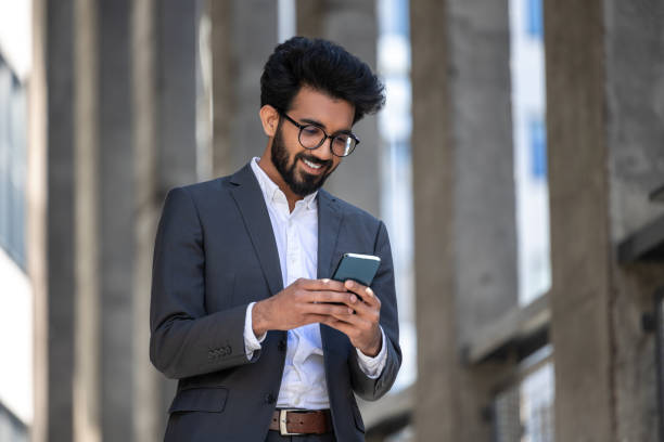 istock Stylish brunette in elegant suit with phone in hands 1924837164