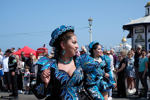 Eastbourne, United Kingdom - May 27 2023: Crowds gather in bright sunshine along the seafront of this popular seaside town to enjoy the Eastbourne Carnival, Eastbourne Carnival 2023, Eastbourne, England, United Kingdom