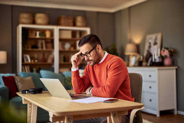 istock A male freelancer under stress over a new project from his client while sitting in front of a laptop. 1924847659