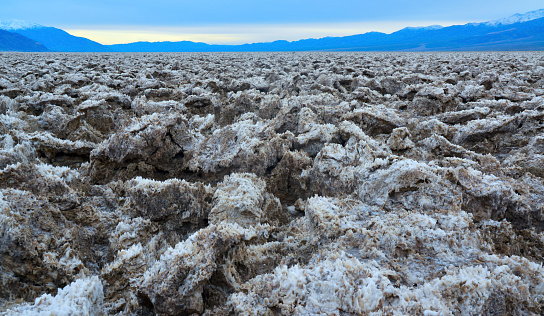 Salt with clay, Smooth salt valley with cracked and swollen salt, dead salt landscape, Death Valley National Park, California