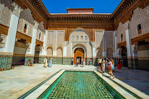 Marrakech,Morocco 19 May 2023:Tourists visiting the Ben Youssef Medersa,old Koranic school