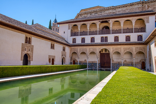 Granada, Spain - August 31, 2023: Patio de Camares reflecting pool in the Palacios Nazaries of the Alhambra of Granada