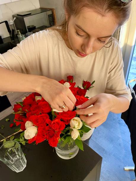 istock A young woman makes a bouquet of red roses 1924924861