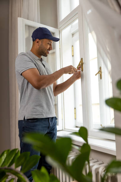 Professional handyman fixing window handle at home.
