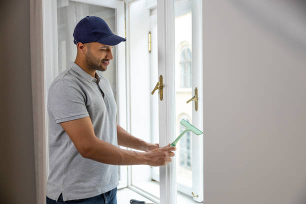 istock Bearded man washing dusty window in apartment. 1924941569