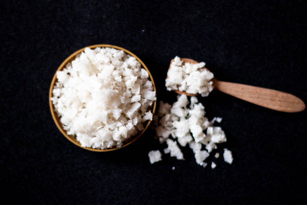 istock Salt in wooden spoon isolated on black background 1924955884