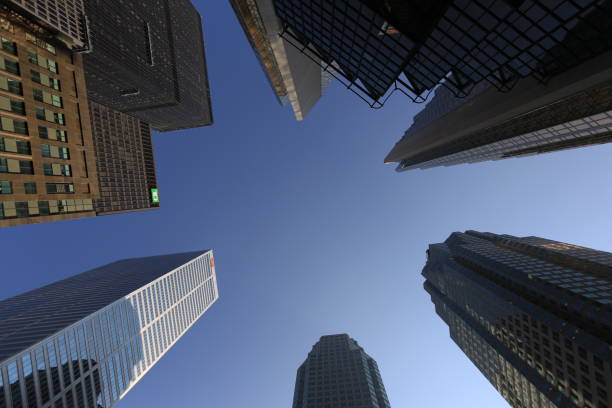 Toronto, Canada - July 13, 2025: Fisheye view of towering skyscrapers with glass and steel facades reflecting sunlight in the Financial District.