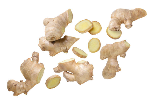 istock Ginger rhizome and pieces flying close-up on a white. Isolated 1924971070