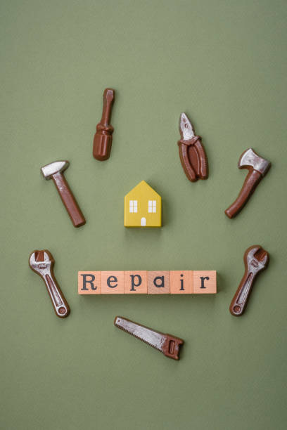 istock Repair or home improvement tools and a house model on a plain background 1924976893