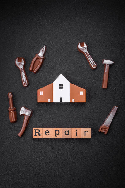 istock Repair or home improvement tools and a house model on a plain background 1924982237