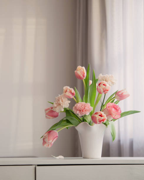 istock pink spring flowers in white ceramic vase in modern home interior 1924998778