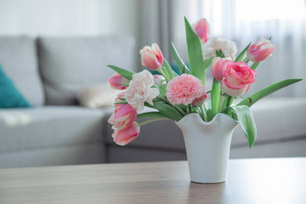 istock pink spring flowers in white ceramic vase in modern home interior 1924999294