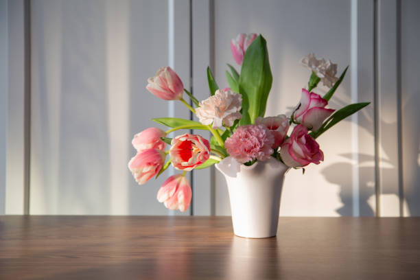 istock pink spring flowers in white ceramic vase in modern home interior 1924999311