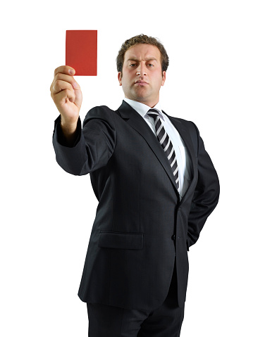 Businessman showing a red card on white background
